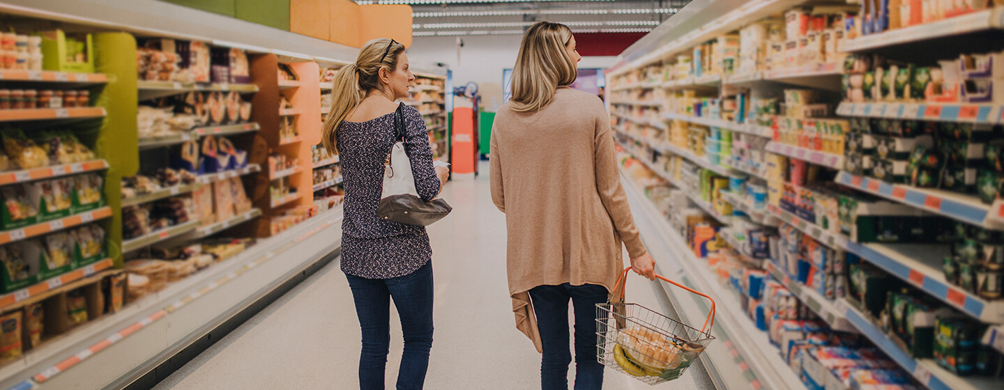 Two women shopping in a retail supermarket